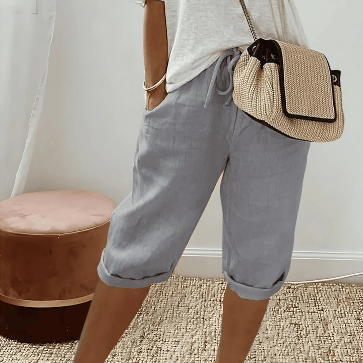Relaxed fit women's harem shorts with elastic waist, high rise, and knee-length for comfortable summer vacation wear.