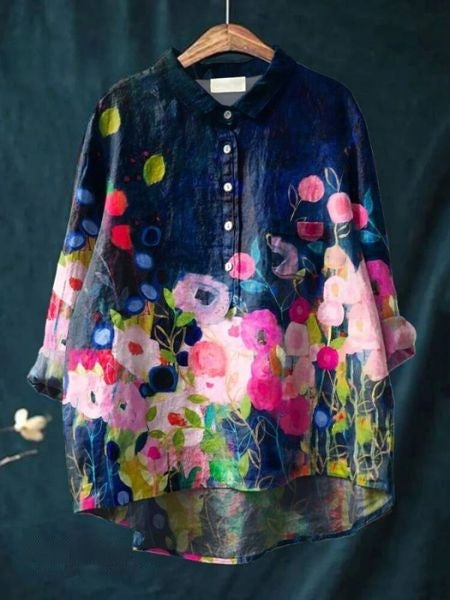 Flat lay: Vibrant floral print women's blouse. Elegant long sleeve top for chic spring/summer style.