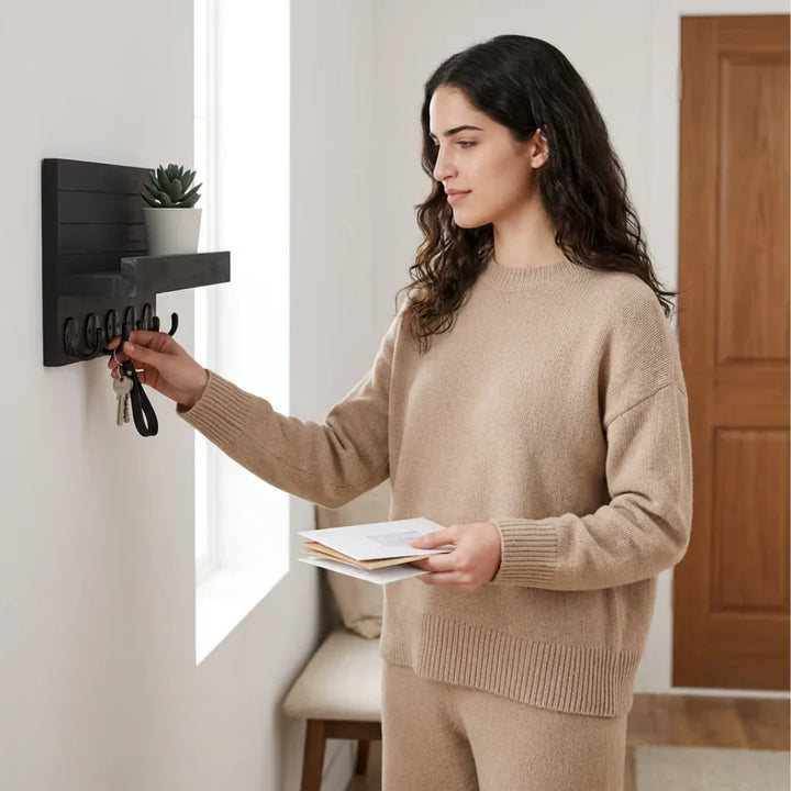 Decorative black entryway wall organizer with key hooks, mail slot, and storage shelf. Ideal for home decor.