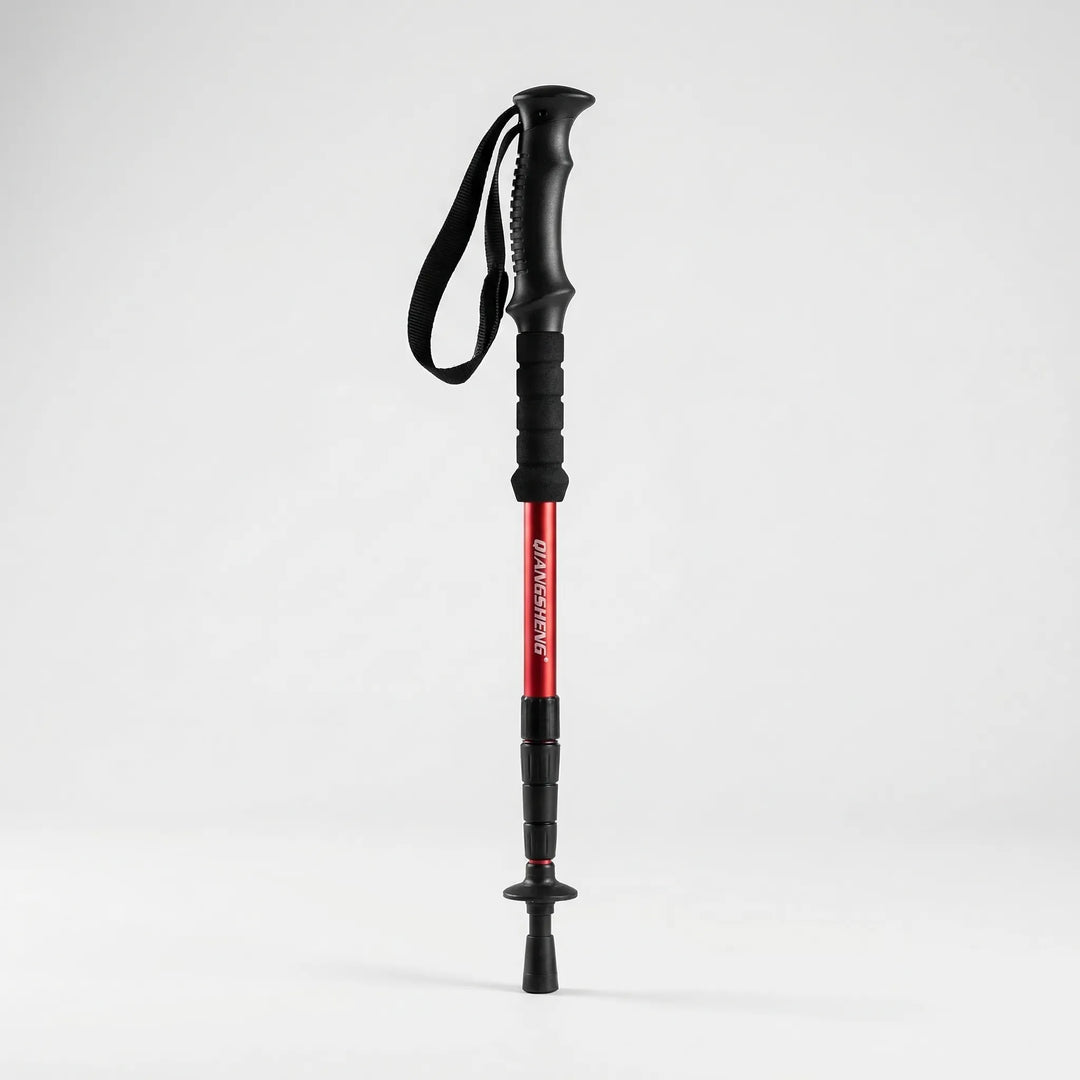Hiker using a collapsible trekking pole on a mountain trail, essential outdoor gear for stability & adventure.