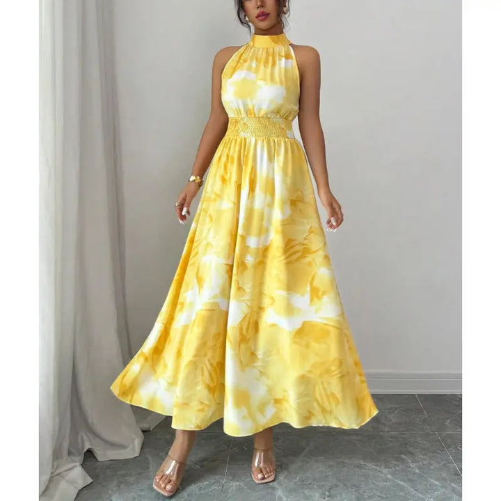 Elegant sleeveless maxi dress for women, featuring a halter neck, smocked waist, and unique pink abstract print.