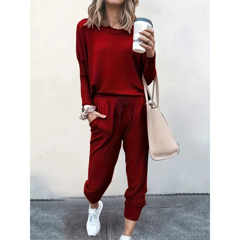 Stylish women's jogger set, a versatile two-piece outfit with crew neck top & tapered pants for casual outings.