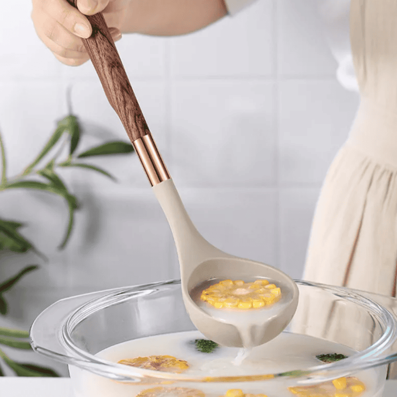Elegant 10-piece silicone kitchen utensil set, including spatulas, ladles, and whisks, neatly arranged in a holder.