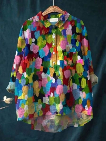 Women's elegant floral blouse paired with pants, showcasing a chic summer/spring outfit.