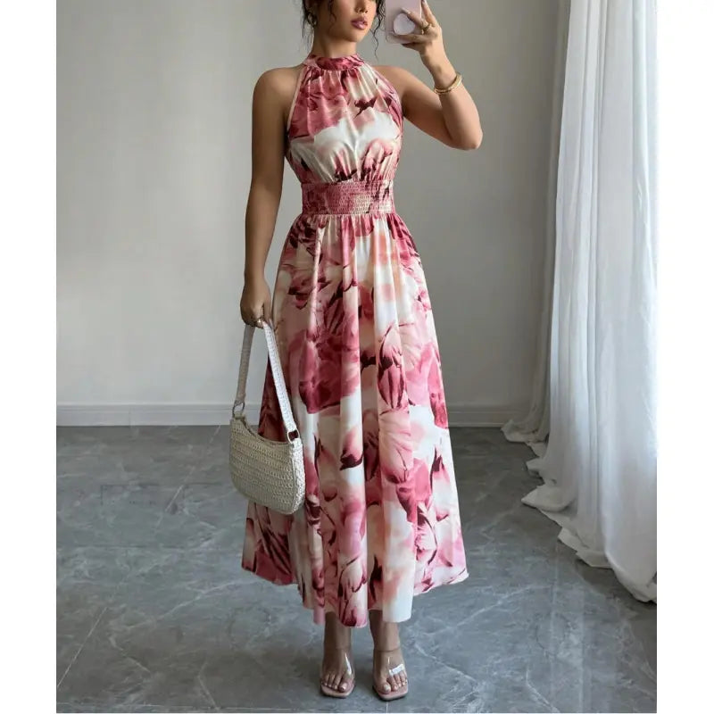Stylish women's summer maxi dress with a flattering halter neck, comfortable smocked waist, & bold abstract pattern.
