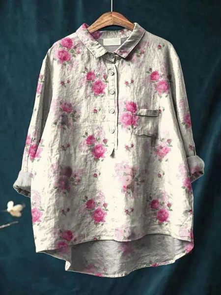 Close-up on floral pattern & fabric of elegant women's long sleeve blouse. Chic spring/summer top.