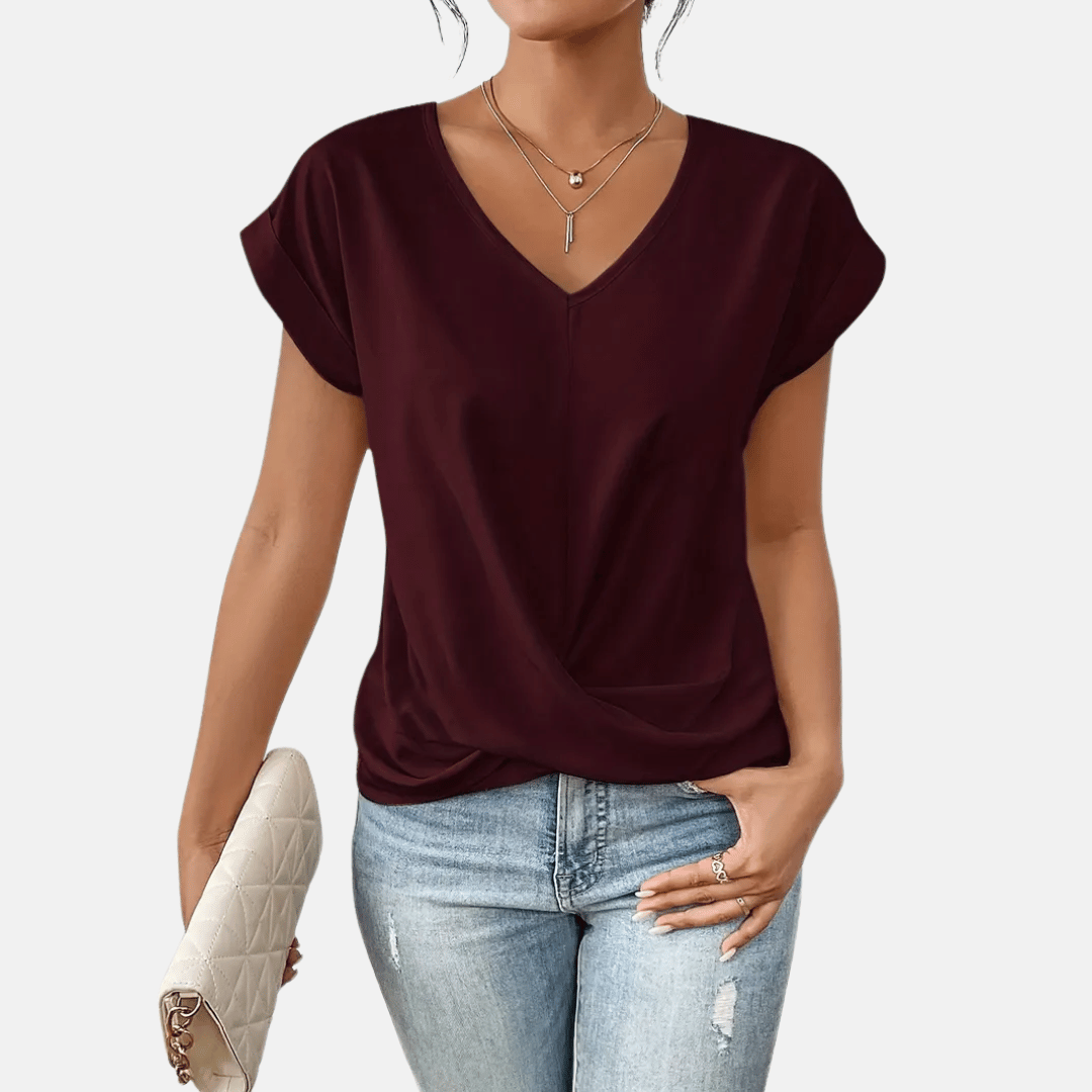 Chic women's short sleeve V-neck blouse with a unique draped hem, offering elegant & comfortable wear.