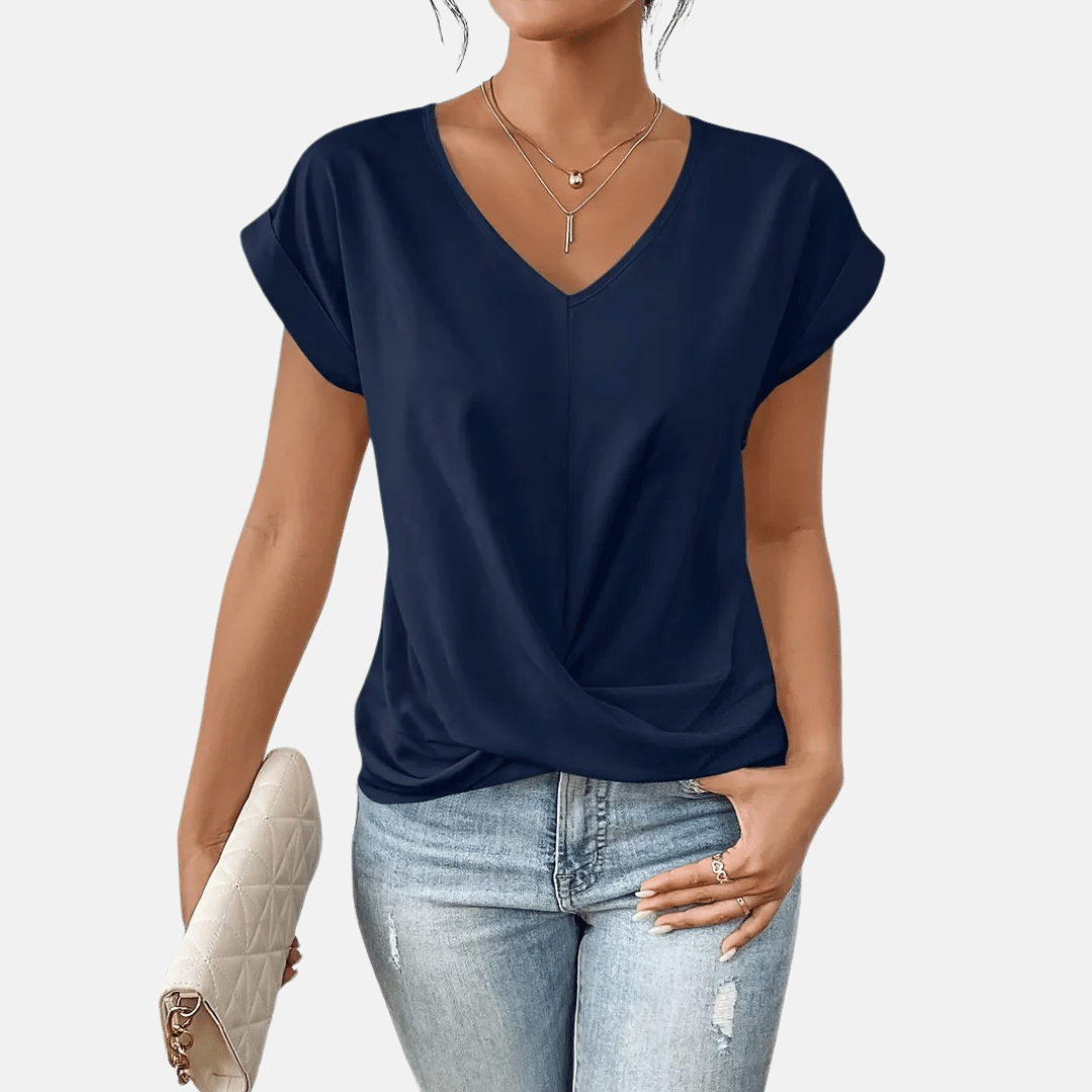 Women's solid color short sleeve V-neck blouse with a draped hem. Perfect for casual spring outfits.