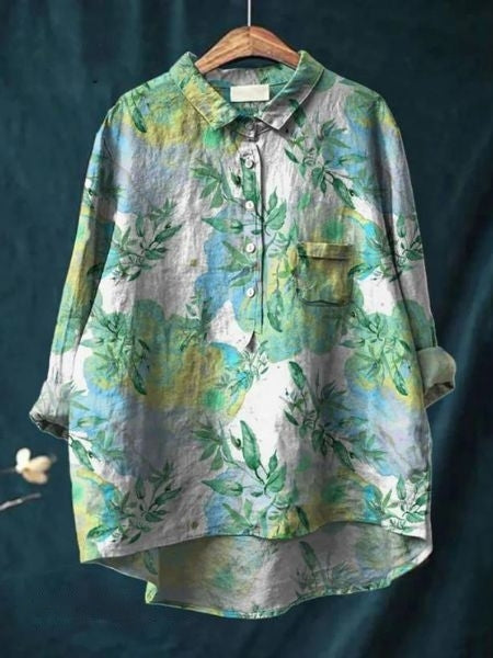 Women's elegant floral blouse, highlighting its flowy design. Perfect long sleeve top for versatile style.
