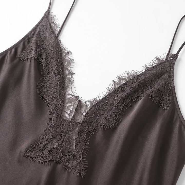 Elegant women's sleeveless V-neck slip dress featuring an asymmetrical hem and intricate openwork trim.