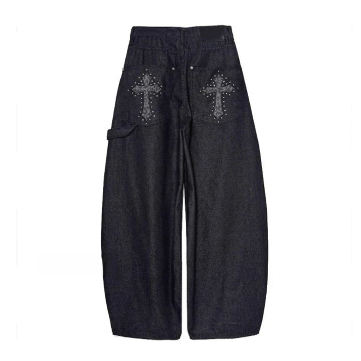 Statement women's baggy wide-leg pants in black, showcasing a studded cross detail. Essential for punk rock style.