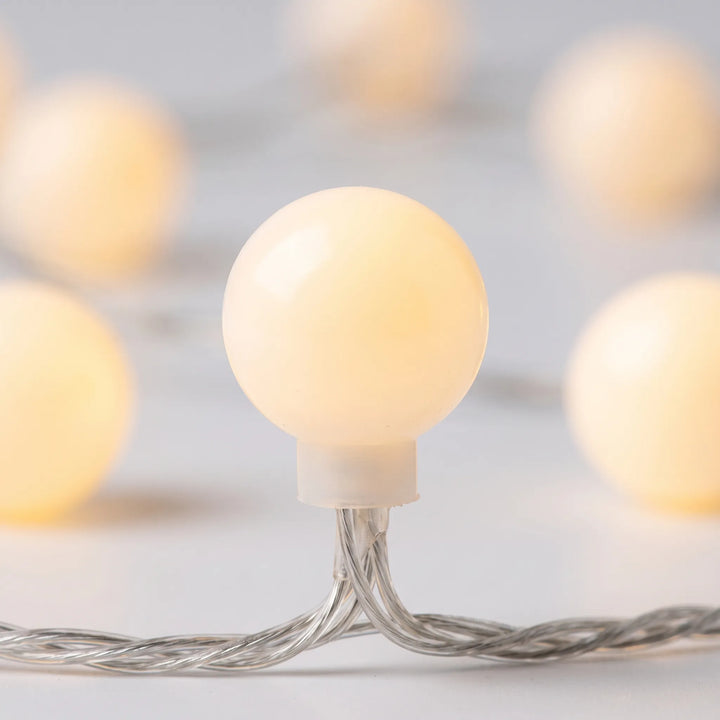 Warm white LED globe string lights, creating a soft, cozy glow for indoor & outdoor spaces.