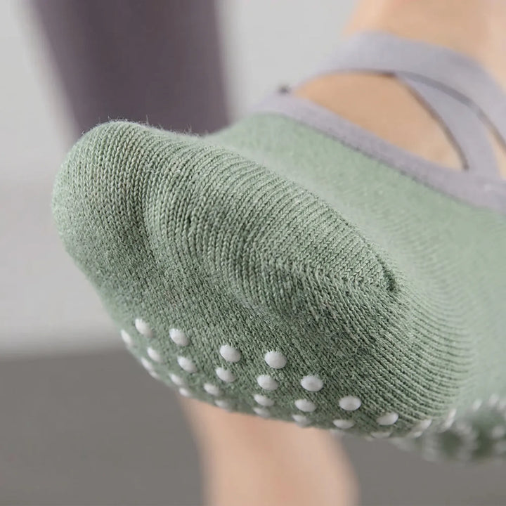 Comfortable women's green studio grip socks with non-slip soles, ideal for pilates and fitness classes.