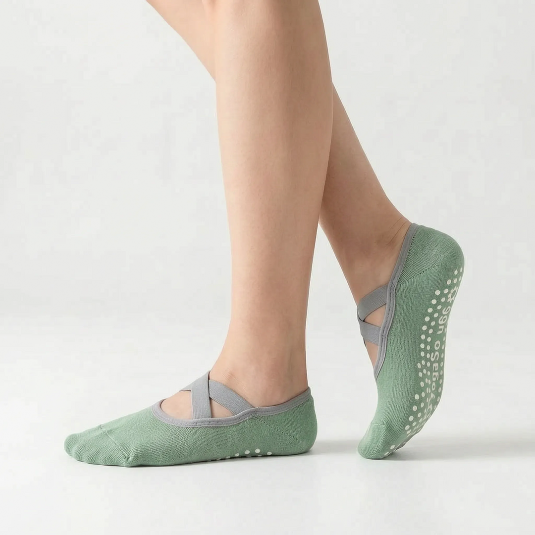 Green women's activewear grip socks, designed for studio fitness like yoga, ballet, and barre, with non-slip sole.