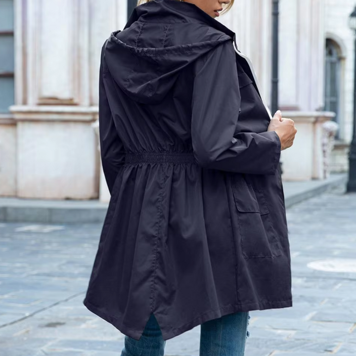 Modern women's zip-up trench coat, a sophisticated and lightweight long jacket, perfect transitional outerwear.