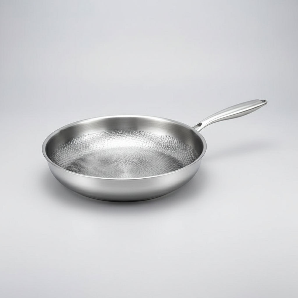 Easy-clean, non-stick frying pan with a unique hammered design, suitable for all induction cooktops. Durable kitchenware.