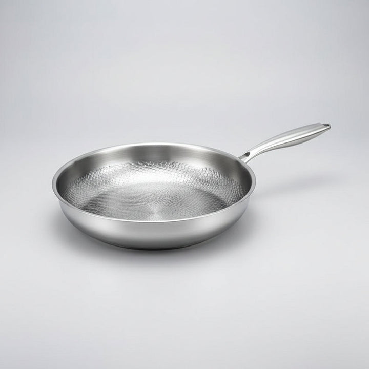 Easy-clean, non-stick frying pan with a unique hammered design, suitable for all induction cooktops. Durable kitchenware.