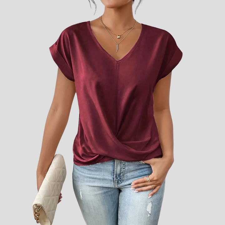 Versatile women's V-neck top with a beautiful draped hem. Short sleeve design, ideal for summer elegance.