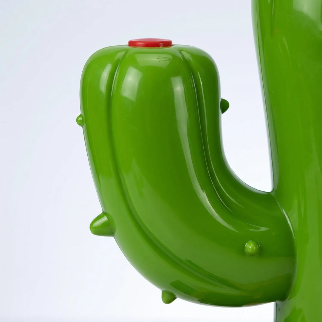 Fun outdoor water game: rotating cartoon cactus sprinkler bringing summer joy.