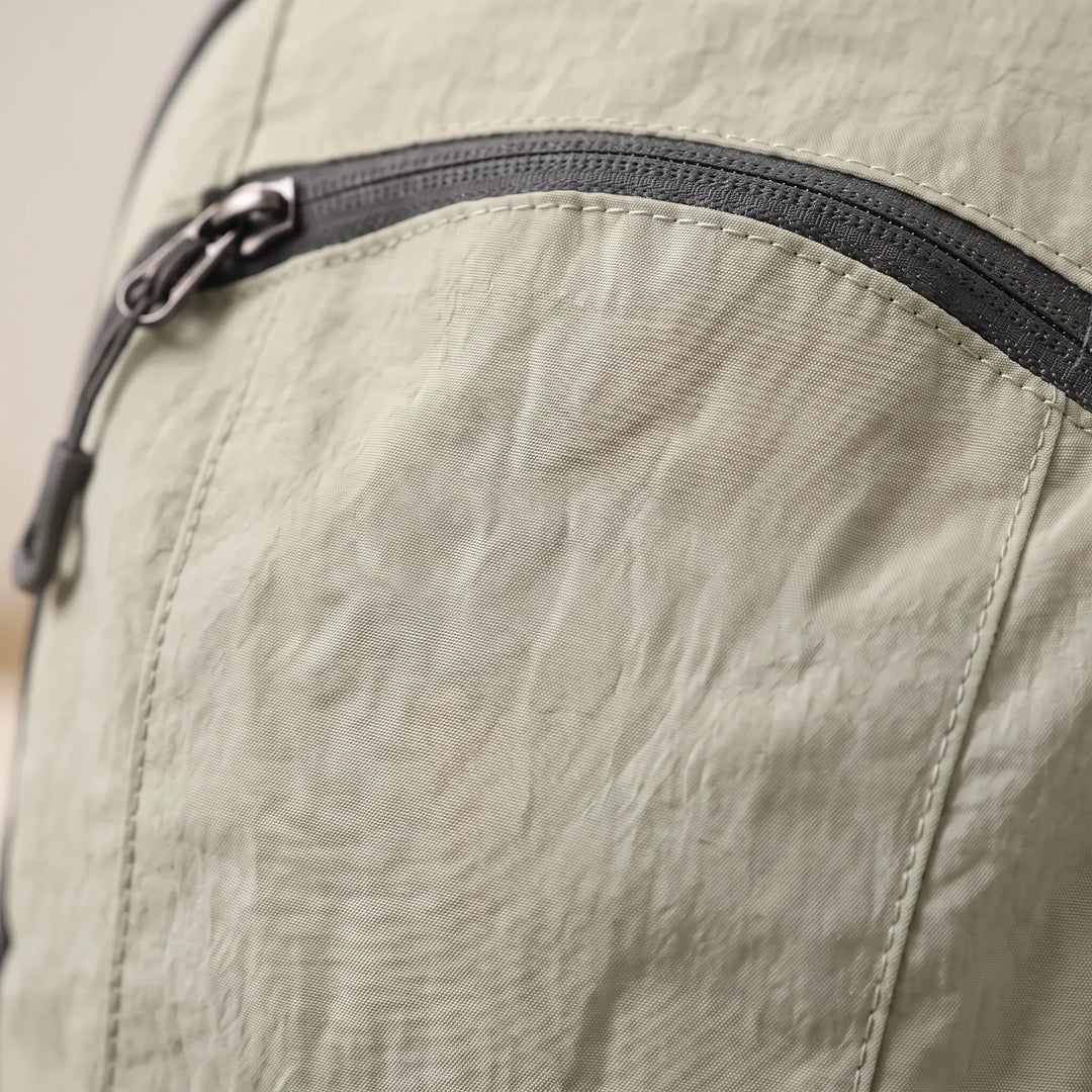Everyday lightweight travel backpack with multiple organization pockets, side view.