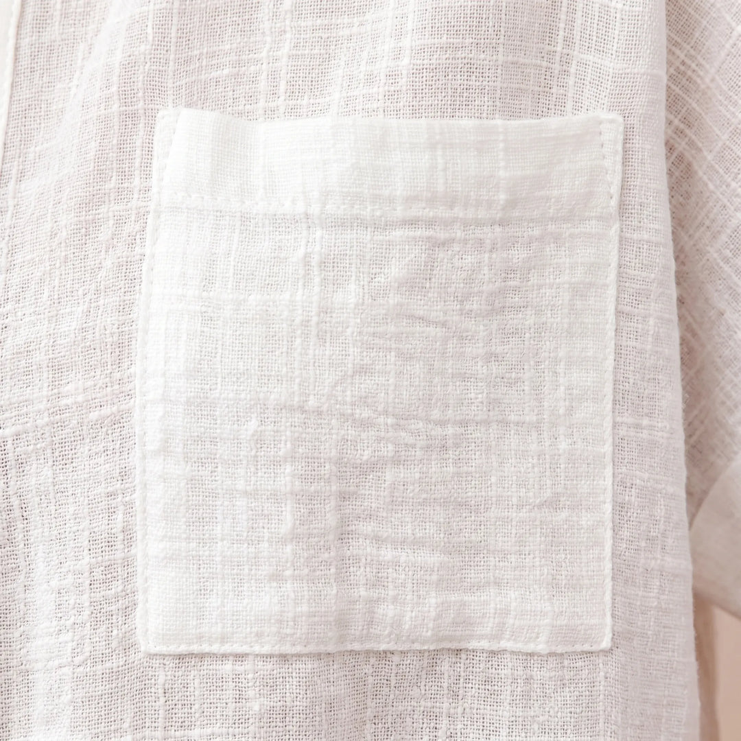 Relaxed fit women's short sleeve blouse with a button-down front & practical chest pocket. Comfortable everyday style.