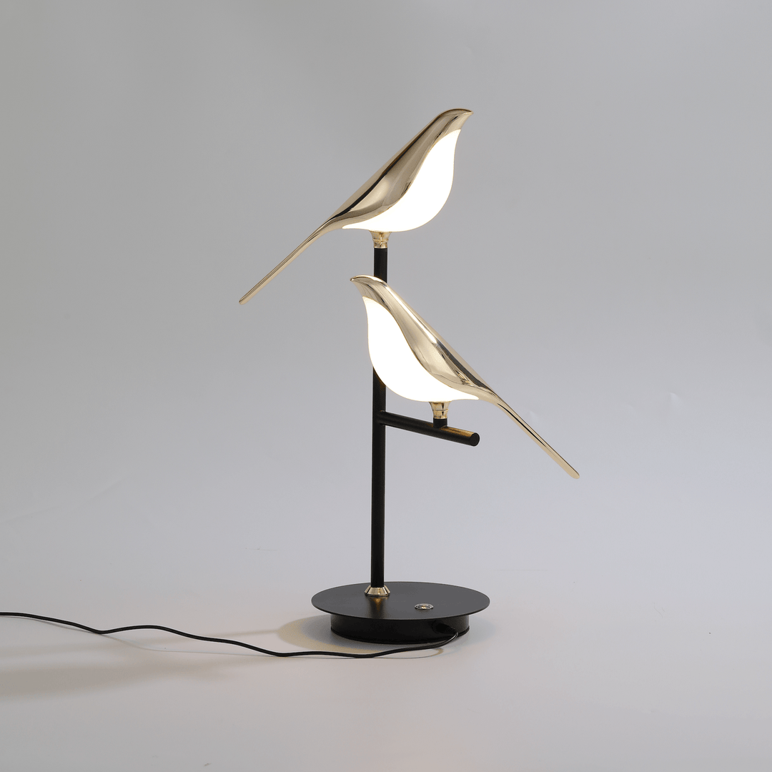 Elegant LED avian wall light with a luxurious gold finish. Decorative bird sconce for contemporary homes.
