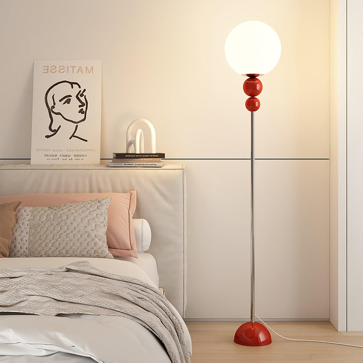 Green contemporary floor lamp with metal & glass, perfect for home accent lighting.