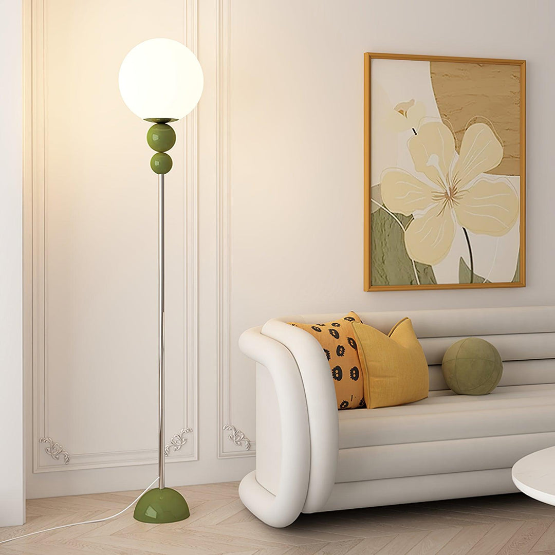 Elegant indoor green metal & glass floor lamp, ideal for modern bedroom ambiance.