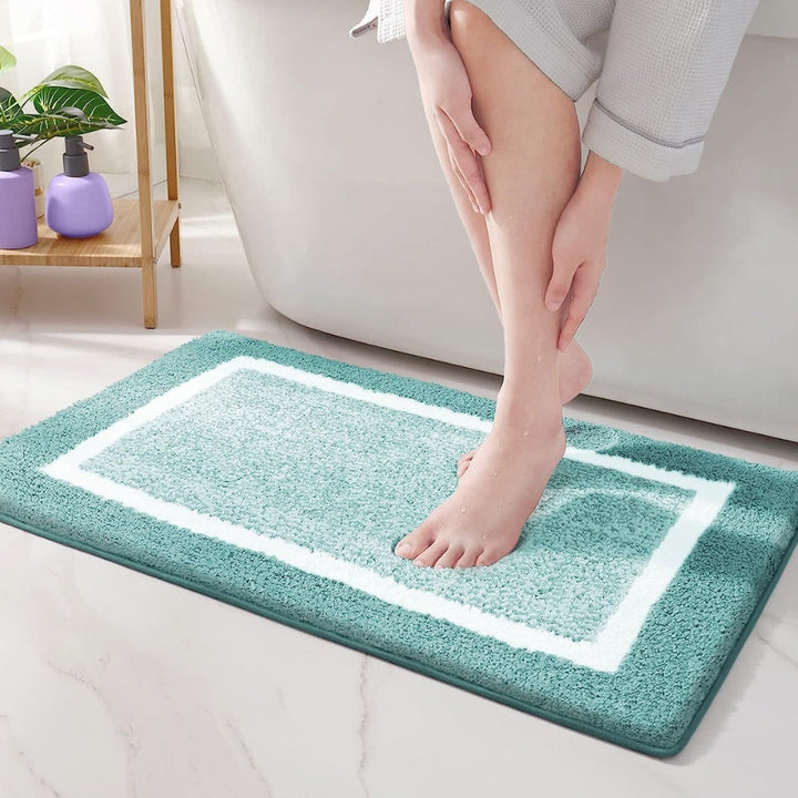 Plush microfiber bath rug in a modern design; non-slip for enhanced bathroom safety. Quick dry, washable bath mat.