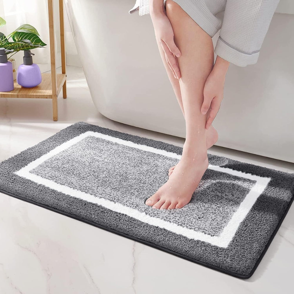 Unisex plush microfiber non-slip bath rug in a modern bathroom setting. Quick dry & washable home safety mat.