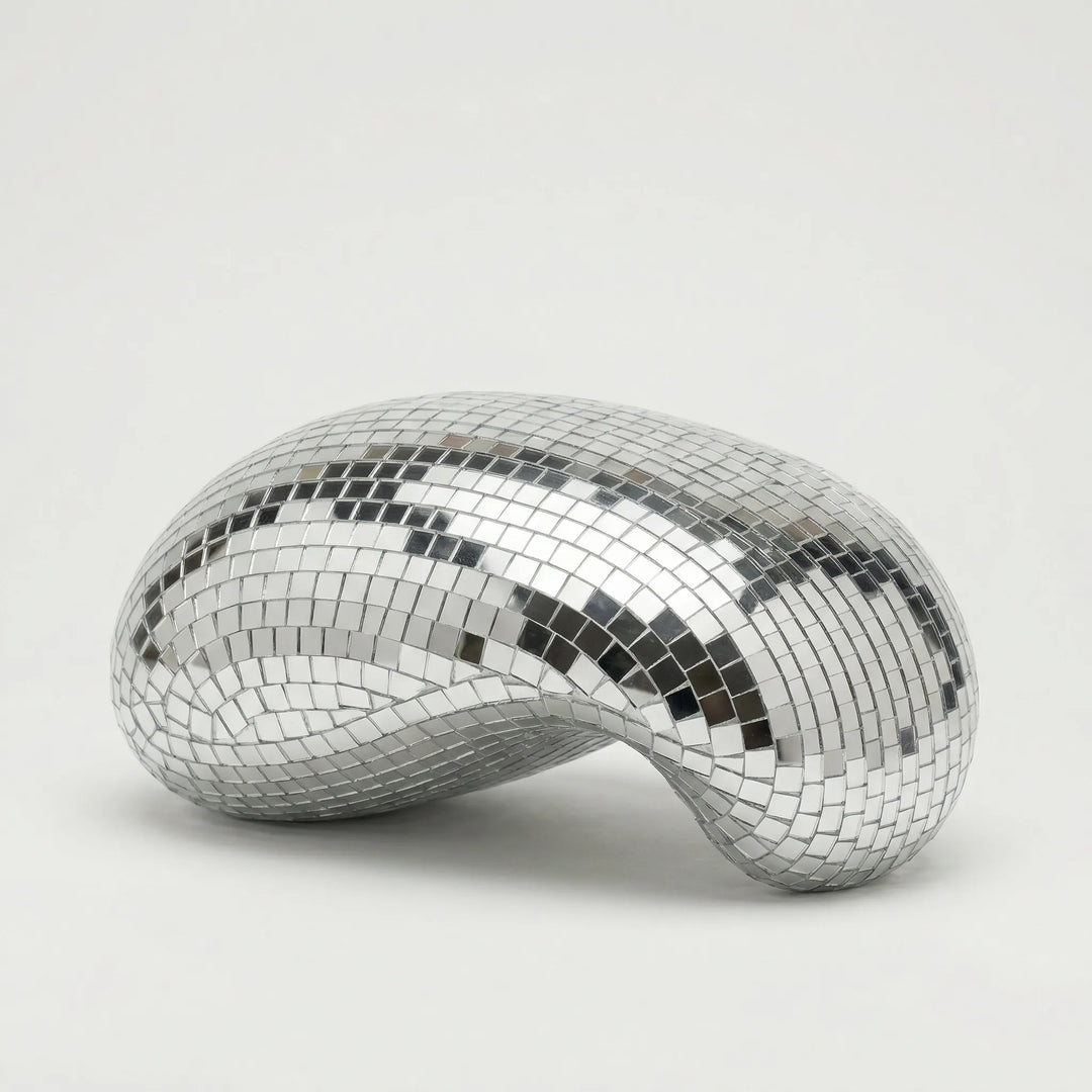 Unique LustraCurl tabletop sculpture, a modern light art piece creating dynamic reflections for living room or office.