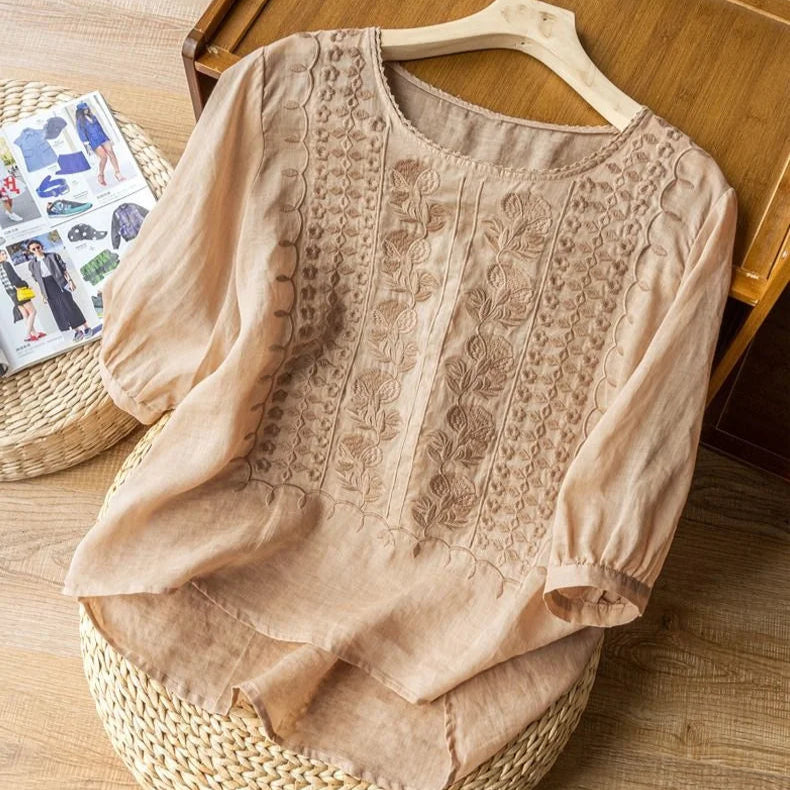 Women's vintage-inspired sheer puff sleeve blouse. Embroidered round neck, three-quarter sleeves, romantic top.