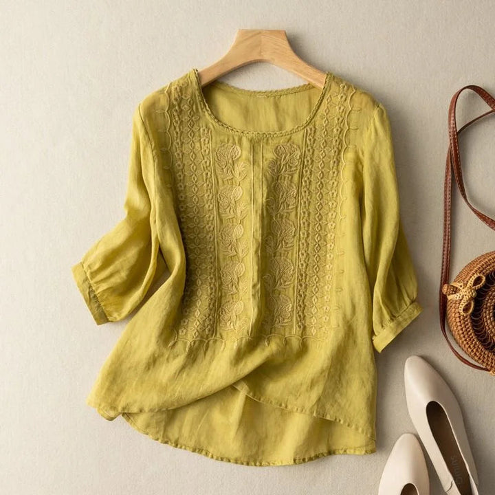 Elegant women's sheer puff sleeve blouse. Romantic embroidered top, versatile for casual or dressy occasions.