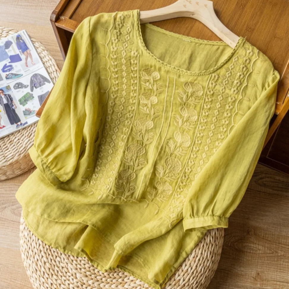Romantic women's blouse: sheer puff sleeves, delicate embroidery, round neck. Feminine and chic vintage top.