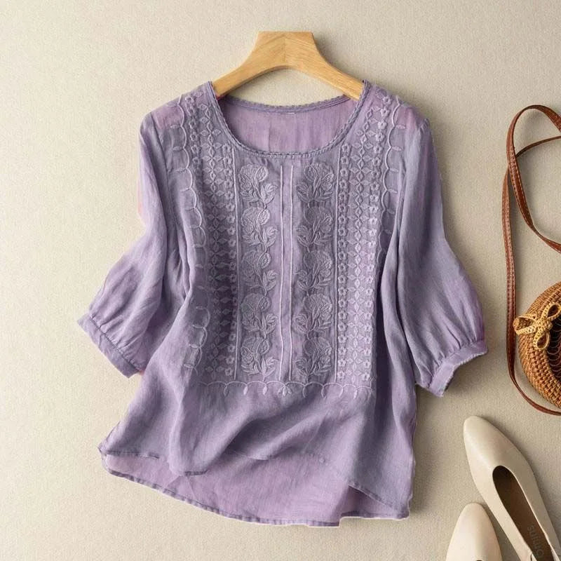 Versatile women's embroidered blouse with sheer puff sleeves. Romantic, round neck, three-quarter sleeve top.