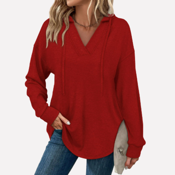 Comfortable women's oversized V-neck hoodie, perfect as a versatile layering piece for trendy fall fashion.