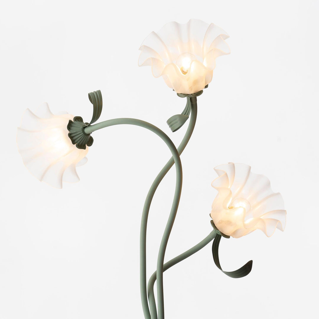 Modern green floor lamp with botanical floral motif, white drum shade, decorative.