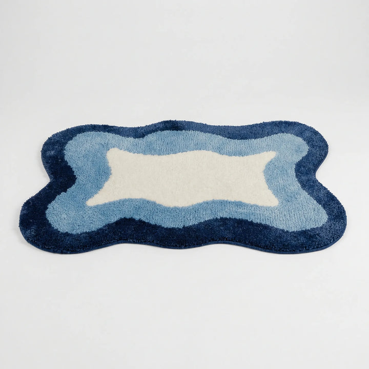Plush Flowique wave bath rug. Soft, absorbent, and a modern statement piece for luxurious home decor.