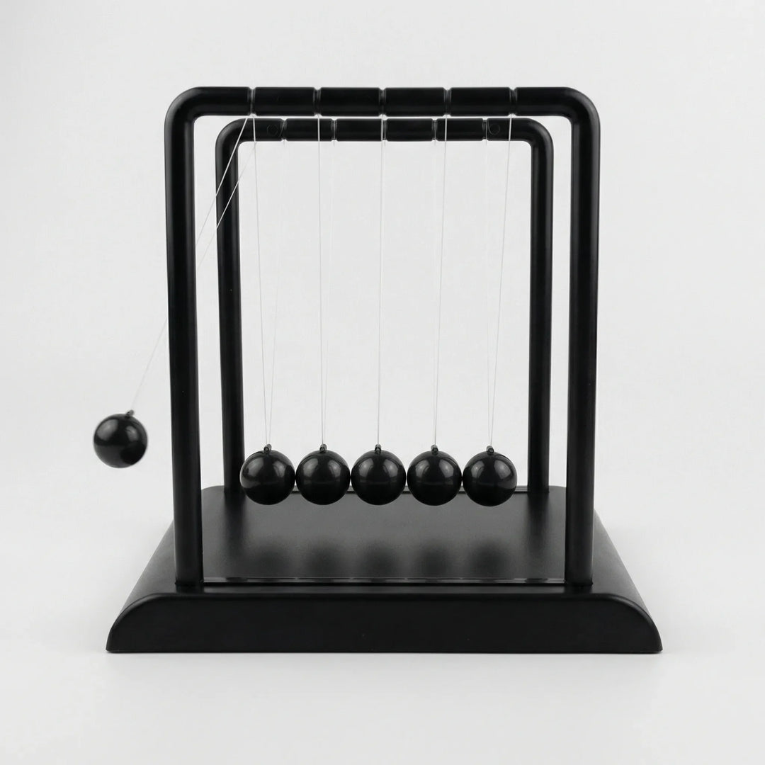 Close-up of modern kinetic desk ornament creating calming motion, ideal for tabletop and office decor.