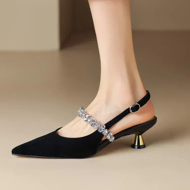 Silver pointed toe slingback pumps with dazzling crystal strap; ideal glamorous formal heels.