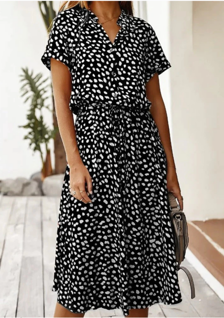 Elegant women's flowy midi dress with chic polka dot print and functional button-down design.