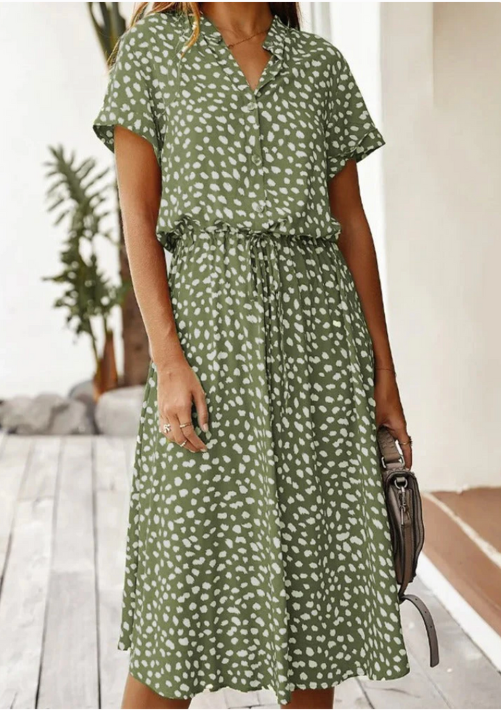 Back view: Women's spotted midi dress, showing flowy skirt, mid-calf length, and versatile style.