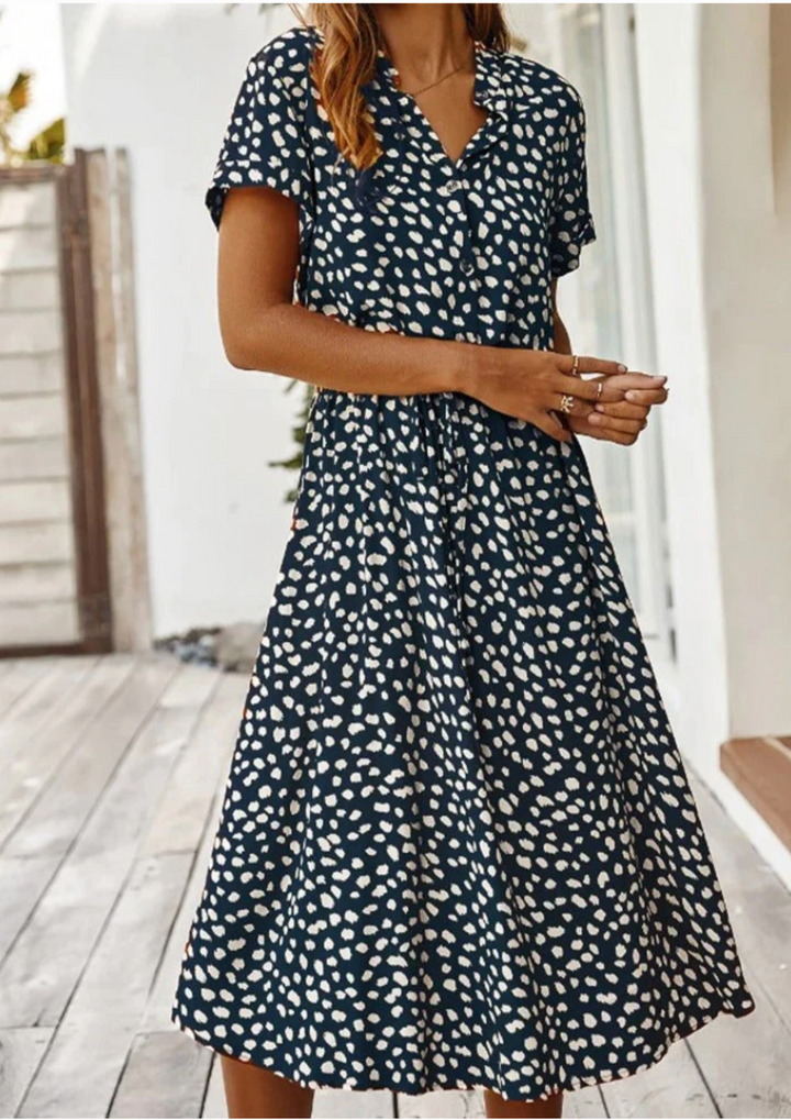 Versatile women's day dress: button-down spotted midi with flattering silhouette and flowy hem.