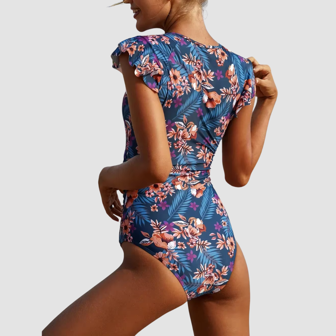 Woman wearing a chic and sporty one-piece swimsuit with a zipper, enjoying a summer vacation by the pool.