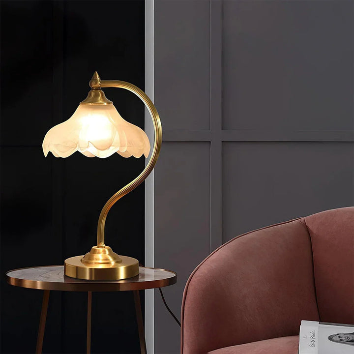 Gold & clear glass floral table lamp, dimmable, adding sophisticated decorative lighting.