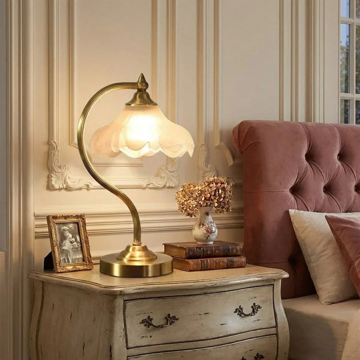 Modern brass accent lamp featuring a delicate floral pattern & dimmable functionality.