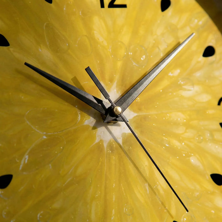 Fun round citrus wall clock with bright yellow design, ideal novelty kitchen decor. A modern home accent.