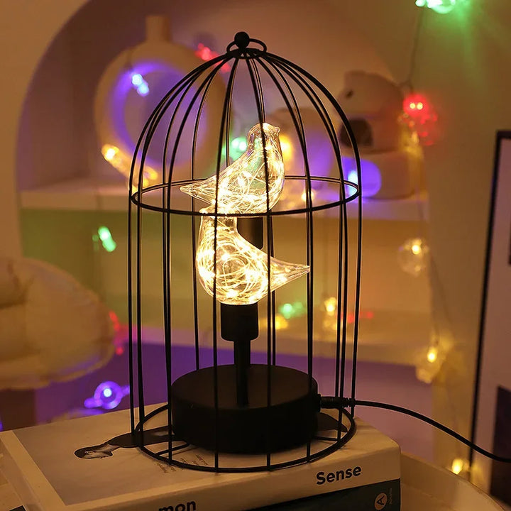 Vintage-style birdcage table lamp featuring a warm LED glow, ideal for decorative accent lighting & home decor.