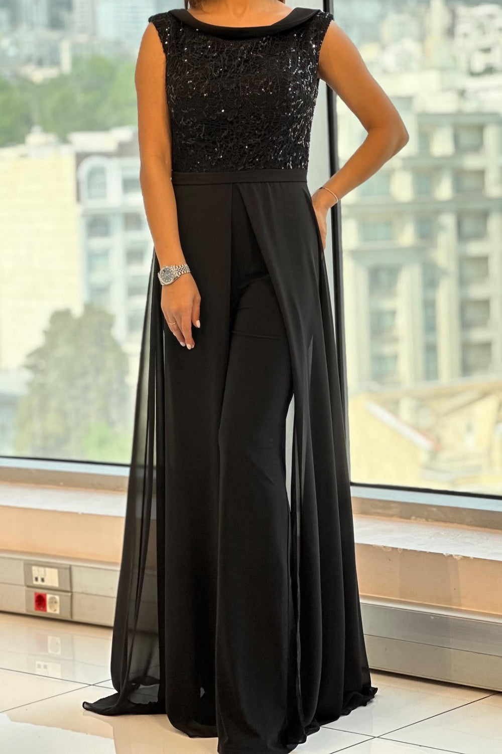Chic women's black textured crew neck jumpsuit, versatile one-piece for modern office, casual, or evening fashion.