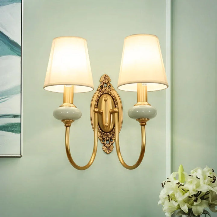 Vintage style copper and ceramic wall lamp for hallway or bedside, adding an elegant touch.